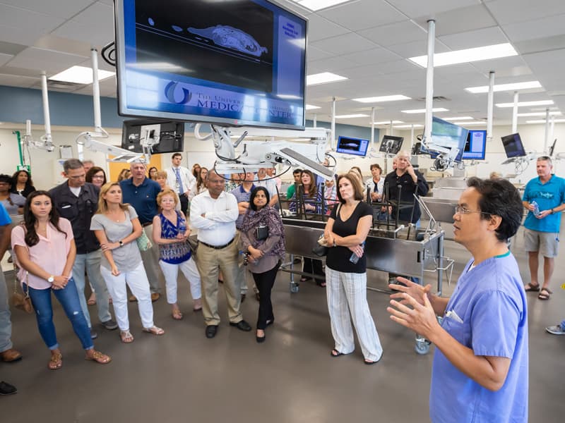 Dr. Yue Lu, right, assistant professor of neurobiology and anatomical sciences, gives a Family Day tour group a quick lesson on the features of the Gross Anatomy Lab.