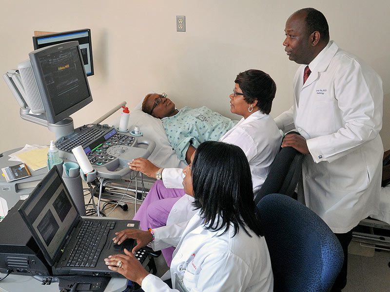 The Jackson Heart Study has been renewed. Since 1998, the NIH-funded project has enabled researchers at UMMC, Jackson State University and Tougaloo College to study cardiovascular health and disease in African-Americans. The study includes physical exams, like the one shown here from 2012 where Dr. Ervin Fox, professor of medicine, monitors as Shari Cook, foreground, and Audrey Samuels, center, take readings from a participant.