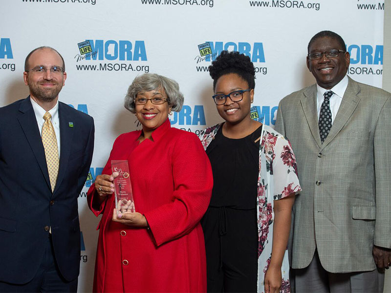 Doris Whitaker, second from left, is MORA's Community Faith Leader or Chaplain of the Year. She's pictured with, on left, MORA chief business officer Russell Touchet; her daughter, Eryn Whitaker; and the Rev. Timothy T. Scott, her pastor at Harvest Celebration Evangelistic Church, where she serves as associate pastor of worship.