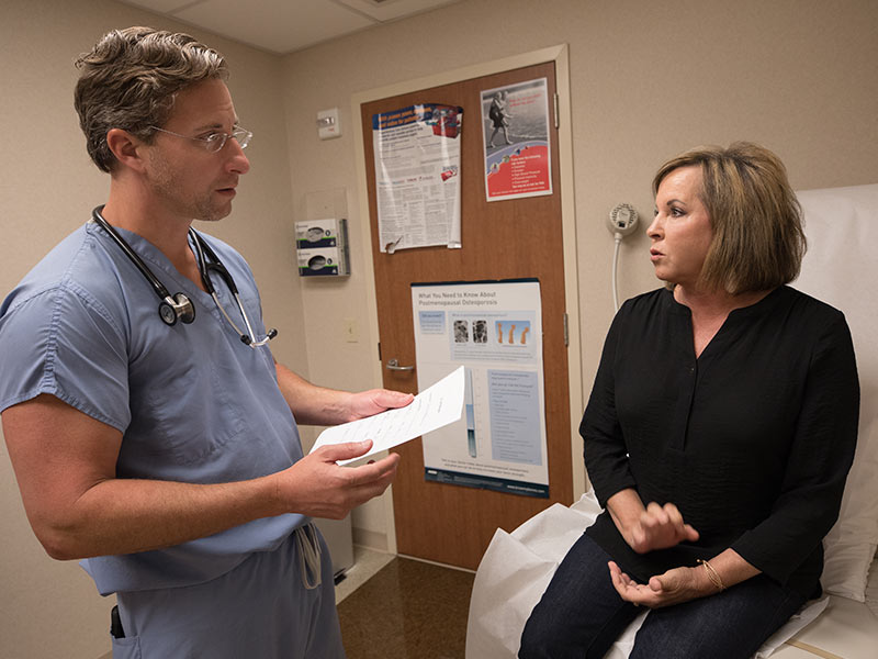 Dr. John Winscott, associate professor of cardiology, and Kim Moore of Flowood discuss her progress following Moore's June 1 heart attack.