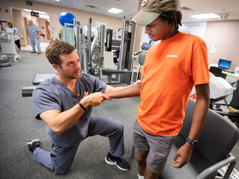 Cody Pannell, physical therapist, works with patient Dominic Jefferson of Jackson.