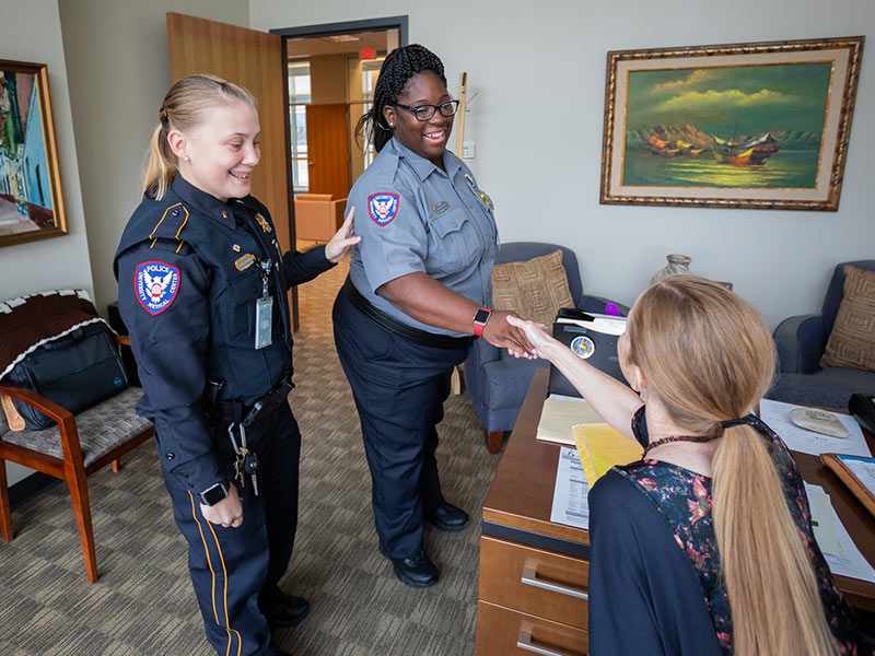 Lt. Toni Sumrall, left, of UMMC Campus Police, introduces Davenia Bass, a new security officer, to Stephanie Lucas, director of research operations for the Department of Physiology and Biophysics.