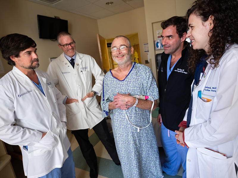 Davis Beasley, center, visits with members of his transplant teams, from left, Dr. Mark Earl and Dr. Christopher Anderson, liver; and Dr. Brian Kogon and Dr. Hannah Copeland, heart.