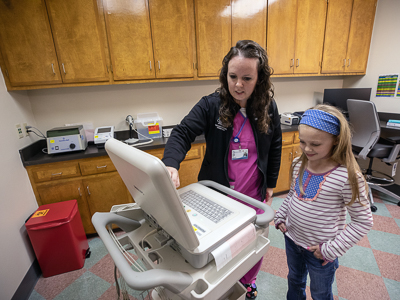 Nurse Ashley Hester gives Children's of Mississippi patient Sybil Cumberland a tour of the new Meridian specialty clinic.