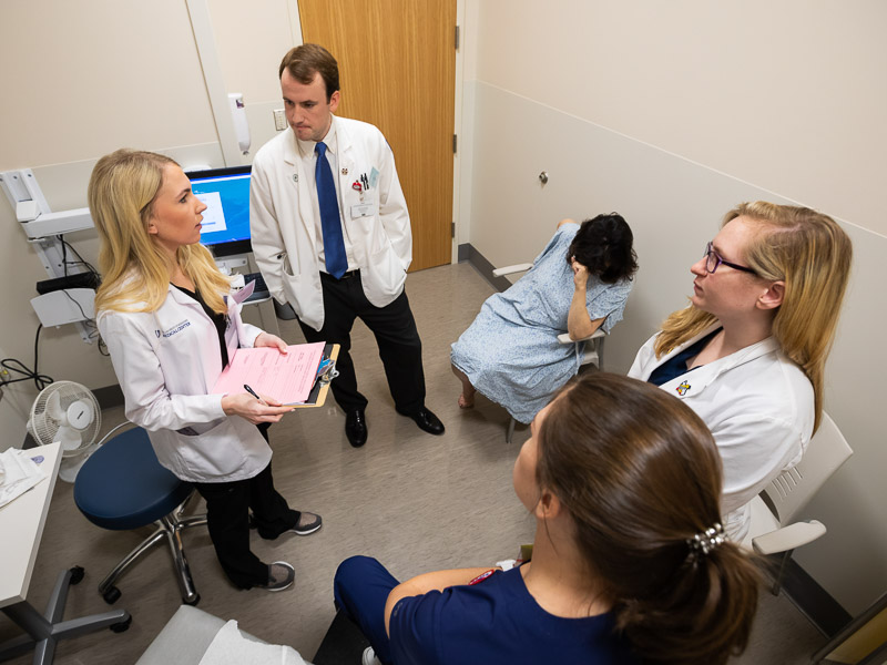 With Standardized Patient Dr. Brenda Sumrall Smith, background, seated, are, clockwise from left: Emily McDermott, Ben Matthews, Alyssa Reid and Madison Quinn.
