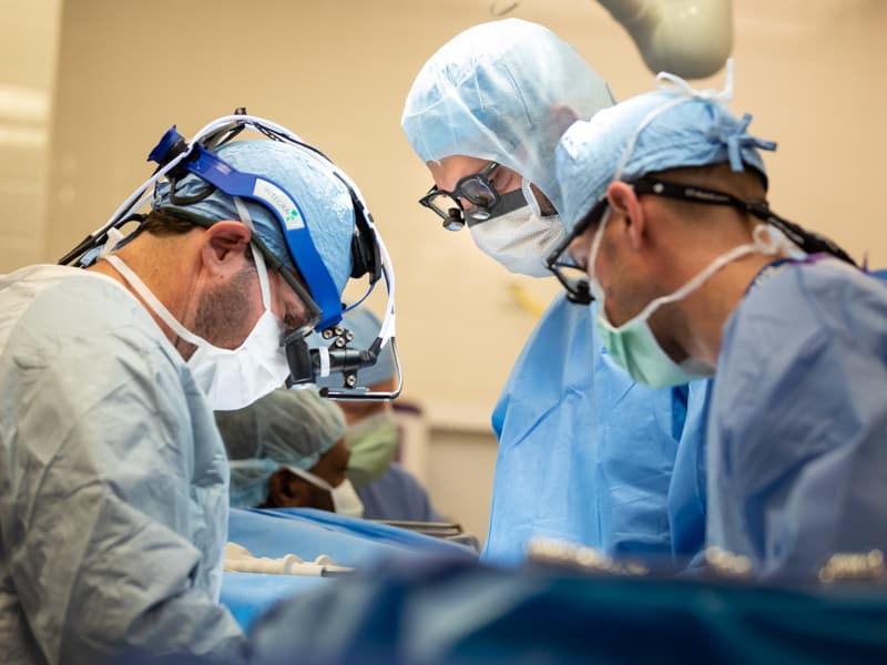 Dr. Mohammed Ghanamah, center, and Dr. Brian Kogon, left, perform a pediatric surgical procedure.