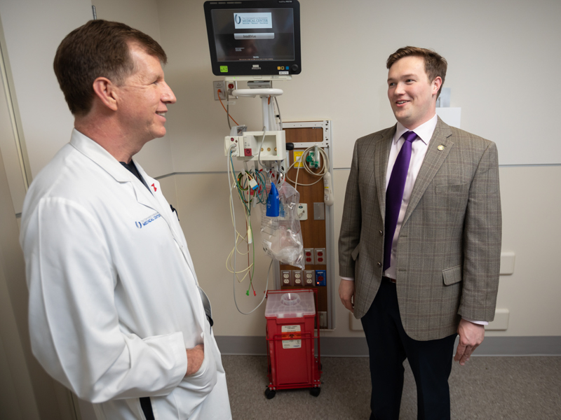 Cardiologist Dr. Mike McMullan confers with congenital heart disease patient Jared Gould of Petal.