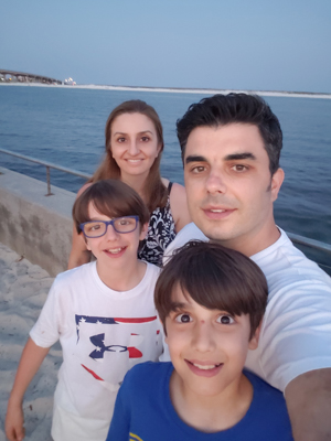 Alper Coban, back right, with his sons Furkan and Kayra, and his wife Seval, at a Florida beach during a soccer trip last year.