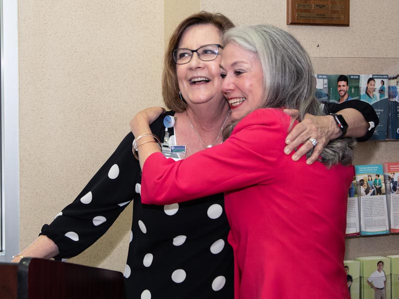 Terri Gillespie, left, chief nursing officer, receives a hug from Dr. Janet Harris after sharing stories about the former interim CEO at Harris' retirement celebration.