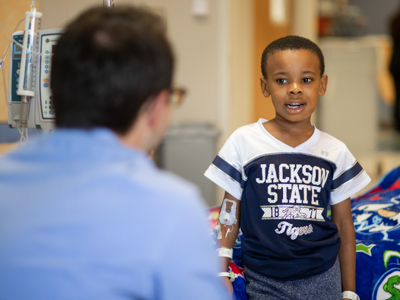 Seven-year-old Princeton Donelson, a patient at Batson, tells Alex Rueff about his family while a patient at Batson. Rueff served in the student chaplain position as a fourth-year medical student.