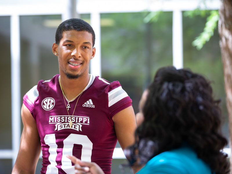 Mississippi State quarterback Keytaon Thompson speaks with Nicole Gladney of Clinton, whose son Kolten Gladney, 9, is a patient at Batson Children's Hospital.