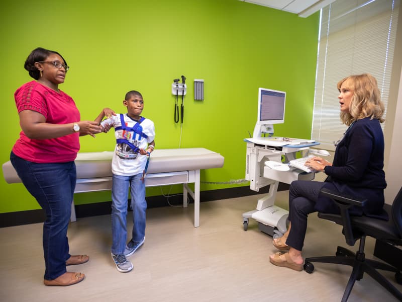 Telicia Walker talks with developmental pediatrician Dr. Cynthia Field about her son, Jadyn, at the new CAY clinic.
