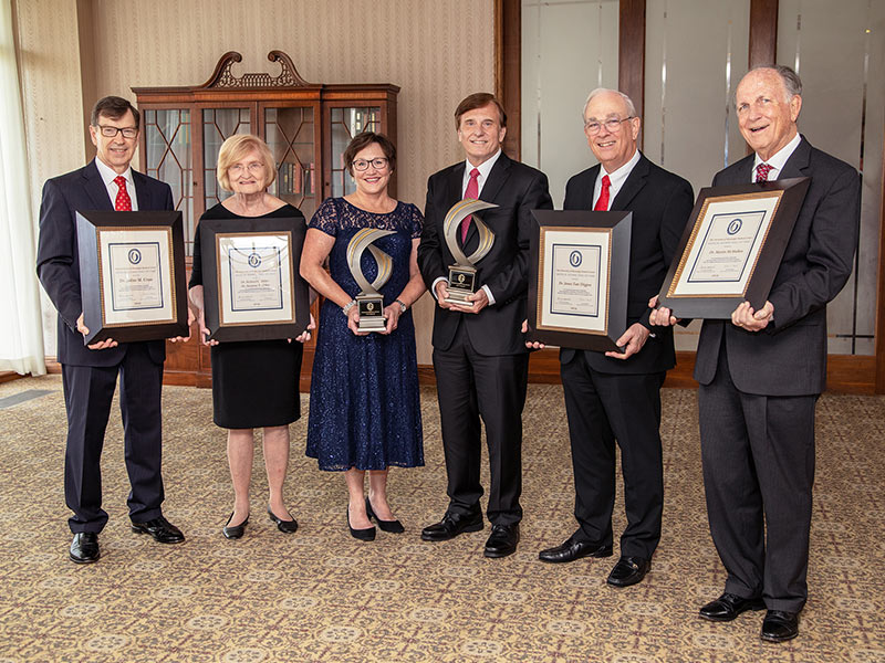Medical Alumni Awards Dinner honorees or their representatives are, from left, Dr. Robert Lewis, accepting for Dr. Julius Cruse Jr.; Dr. Suzanne Miller, accepting for herself and her husband Dr. Richard Miller; Dr. Sherry Martin; Dr. John Fleming Jr.; Dr. Tate Thigpen; and Dr. Mart McMullan. Not pictured is Dr. Ralph Vance Sr., who accepted for Dr. Peter Blake.