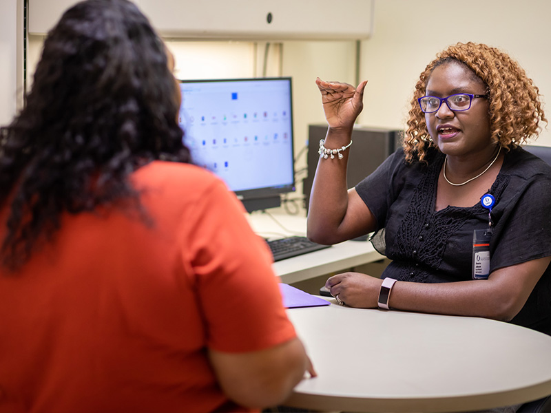 Benetra Mangum-Johnson, right, a social worker at UMMC's Adult Special Care Clinic, counsels Rosemary Hall.
