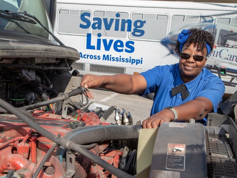 Jacqueline Williams checks oil and fluids of her bus, no. 962, before every shift.