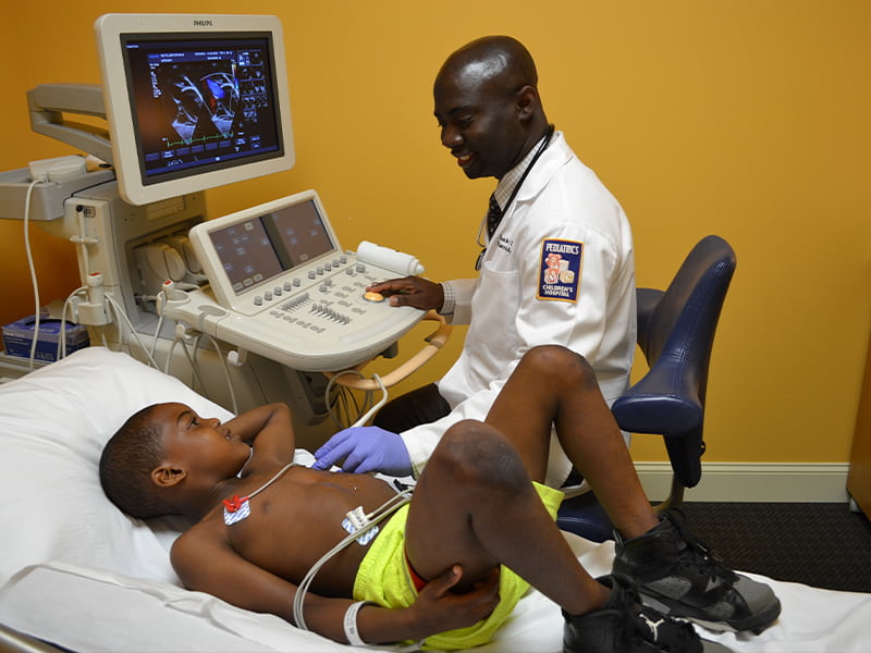 Doctor looks at a pediatric patients heart.