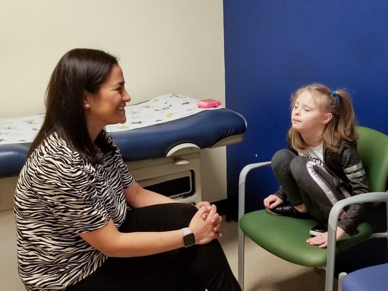 Doctor talks to pediatric patient.