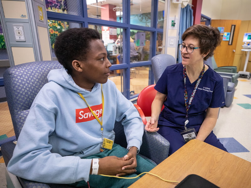 Dr. Melissa McNaull, Children's of Mississippi hematologist, talks with Tyler Jackson of Ridgeland at the Children's of Mississippi Center for Cancer and Blood Disorders.