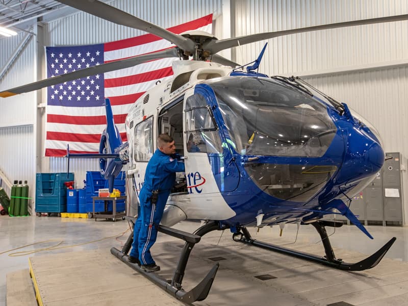 Paul Boackle, a flight nurse with AirCare, readies a helicopter for its next trip.