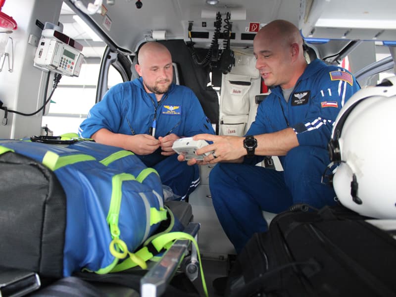 AirCare paramedic Ben White and registered nurse Brock Whitson check equipment prior to a flight. Photo courtesy of Bill Graham/The Meridian Star.