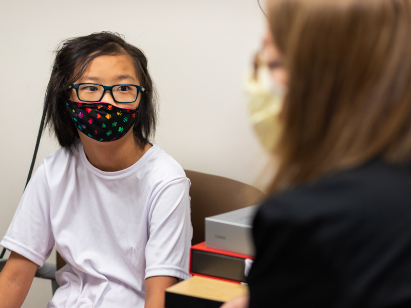 Jocelyn DeZutter, 11, gets her new bone conduction implant checked by Dr. Beth King, an audiologist in the Department of Otolaryngology and Communicative Sciences.