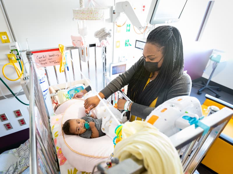 Jessica Carter of Jackson plays with daughter Lyndsey Lee Carter in one of the new private NICU rooms in the Kathy and Joe Sanderson Tower at Children's of Mississippi.