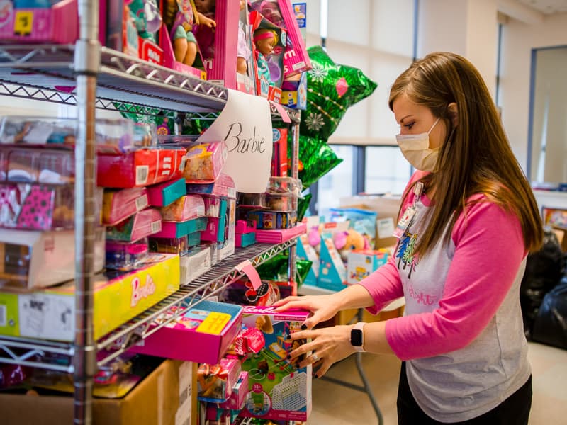 Child life specialist Cara Williams sorts through the many dolls donated for children's hospital patients in this 2020 file photo. Lindsay McMurtray/ UMMC Communications