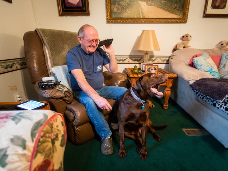 After taking his blood pressure Jan. 21, Stephen Dawkins of Vicksburg received a call from a nurse at the Center for Telehealth to discuss his reading transmitted moments earlier to his electronic medical record. His dog Gabby stays near his side.