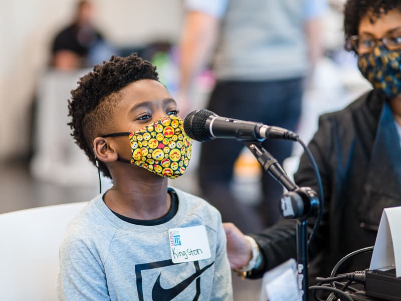 Kingston Murriel of Brandon, a Children's Heart Center patient at Children's of Mississippi, speaks into the microphone during the 20th annual Mississippi Miracles Radiothon.