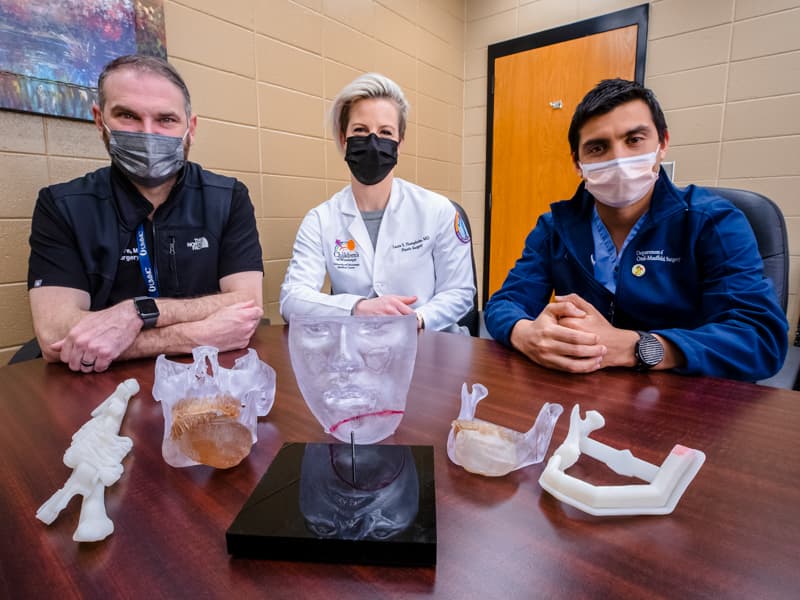 From left, Dr. Benjamin McIntyre, Dr. Laura Humphries and Dr. Ignacio Velasco-Martinez used models crafted for a virtual surgery plan in preparing for Almarie Maldonado Pagan's cancer removal and jaw reconstruction.