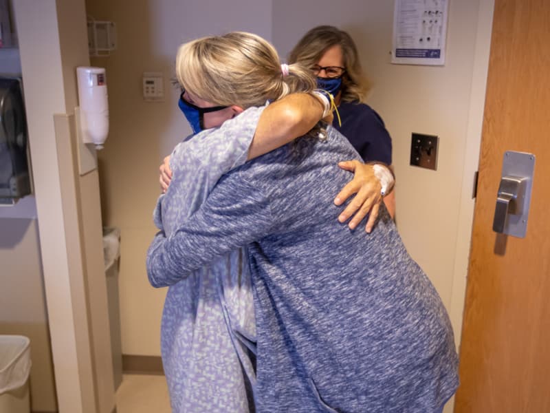 Kidney transplant patient Hugh Smith gives his transplant coordinator, Brandie Garcie, a huge hug before his discharge following surgery.