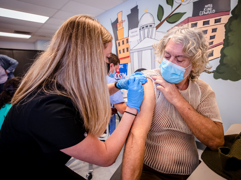 First-year medical student Sydney Hays gives a vaccination to James Davis of Brandon Saturday at the Jackson Free Clinic.