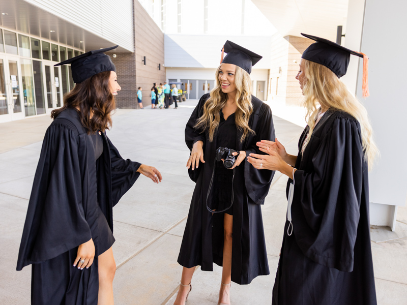 Bachelor of Science in Nursing candidates, from left, Abby Kate Frazier, Alexis Byrd and Haley Penn, chat on their graduation day.