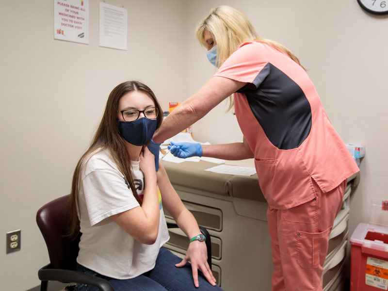 Teens such as Rosemary Williamson, shown getting a COVID-19 vaccination in this May 2021 file photo, are now eligible for booster shots.