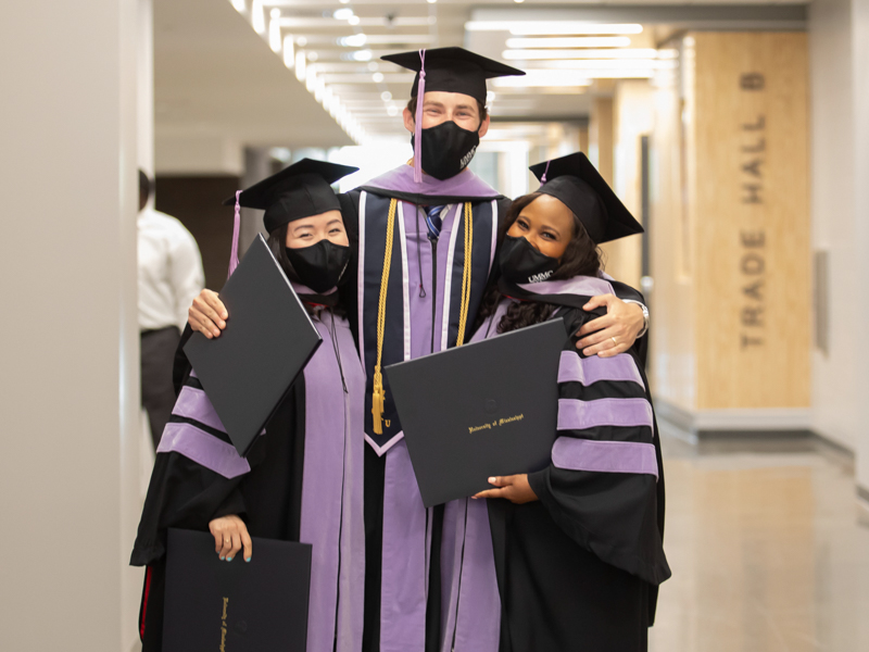 School of Dentistry graduates, from left, Audrey Fortin, Graham Garvey and Jalessa Dandridge celebrate receiving their diplomas following UMMC commencement ceremonies May 28 at the Mississippi Coliseum.