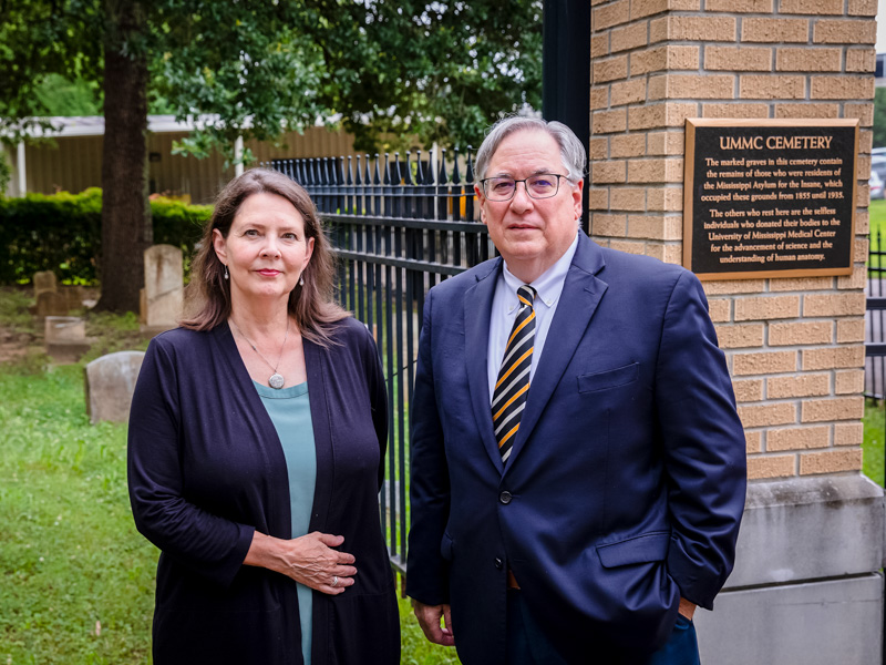 Lida Gibson and Dr. Ralph Didlake visit the UMMC Cemetery, the site of more than 20 relocated stones and the resting place of human remains found in unmarked graves about two decades ago.