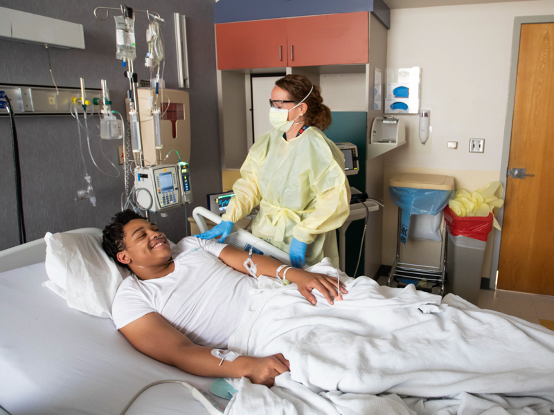 Registered Nurse Helen Ann Campbell checks on Keelyn Green, who is recovering at Children's of Mississippi from a serious bout with COVID-19.