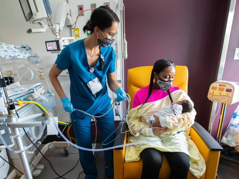 Portia Hayes talks with Taylor-Alice McWilliams, a newborn intensive care unit inpatient nurse, about her son, Jediah Johnson, in the Children's of Mississippi Neonatal ICU.