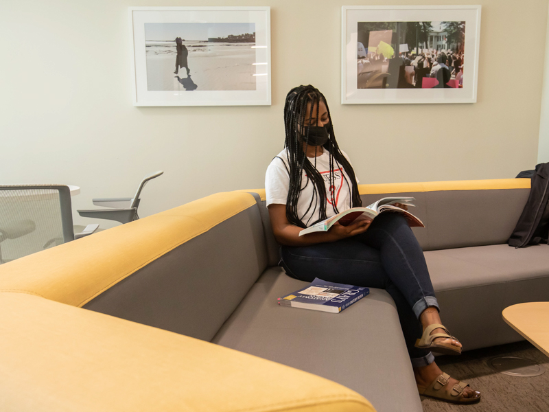 First-year medical student Jayla Mondy studies in the student lounge where part of the "Color Our Walls" student photography exhibit hangs in the School of Medicine.