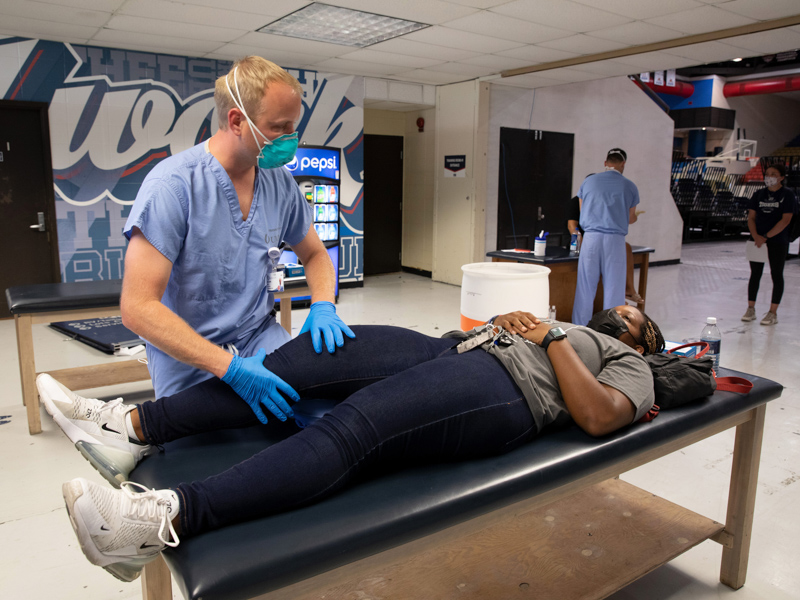 UMMC orthopaedics resident Dr. Rowdy Lee examines Hannah White, a JSU track and field athlete from Chandler, Arizona.