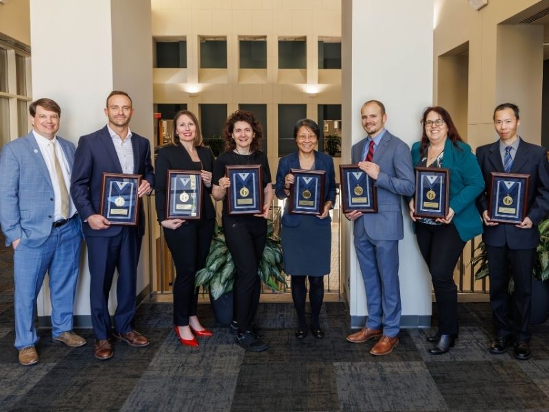 Gold recipients include, from second left to right, Dr. John Clemmer, Dr. Abigail Gamble, Dr. Barbara Gisabella, Dr. Nancy Min, Dr. Alan Mouton, Dr. Daniella Ruedi-Bettschen and Dr.Keli Xu. At left is Dr. Gene Bidwell.