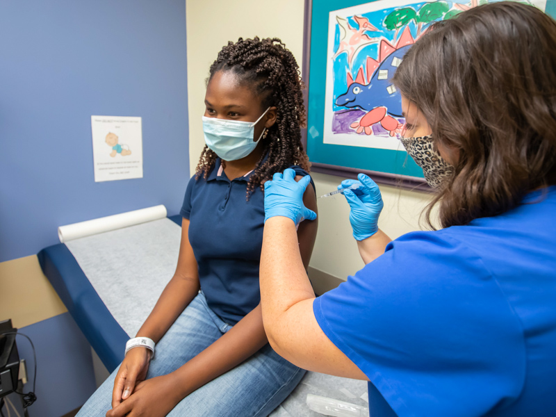 Nurse manager Kristen Cherry gives a COVID-19 vaccination to Lindsey Anderson of Byram at the Batson Kids Clinic.