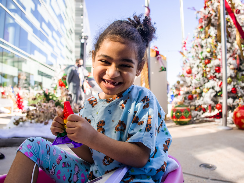 Children's of Mississippi patient Zalayah Miller of Jackson smiles while choosing a Christmas tree.