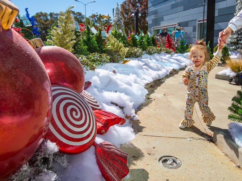 Children's of Mississippi patient Paisley Umberger takes a walk through BankPlus Presents Winter Wonderland.