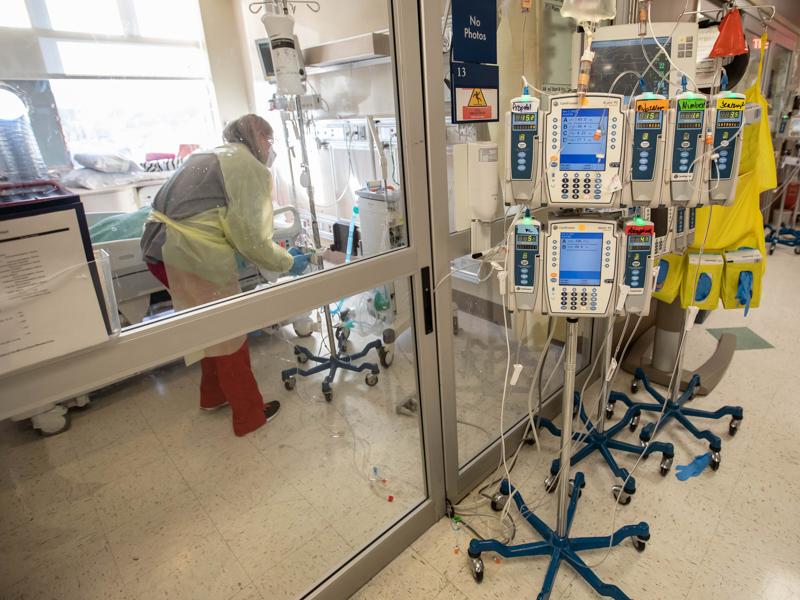 Registered nurse Melissa Davis gives bedside care to an intubated COVID-19 patient in UMMC's Medical ICU.