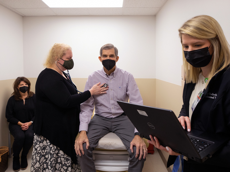 Dr. Laura Smart, second from left, checks the heartbeat of liver transplant recipient Randal Russell as abdominal transplant coordinator Taylor Tadlock, right, takes notes. Also pictured is Russell's wife Sherri, left.