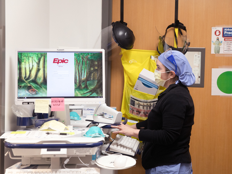 Registered nurse Amy Wigglesworth prepares to enter data gathered at the Clinical Research Trials Unit. She is working on the RECOVER study, a national effort to understand Long COVID.