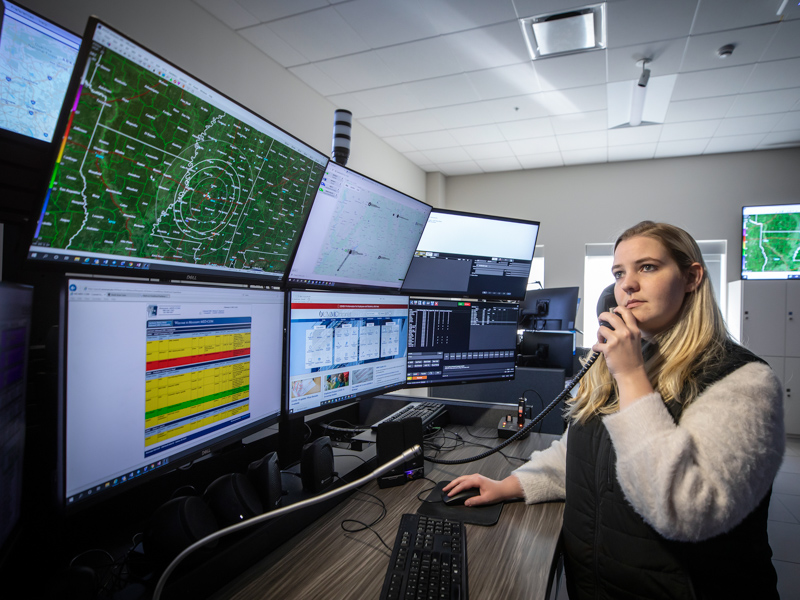 Elizabeth Sullivan, a communications specialist at MED-COM, monitors the weather at UMMC's state-of-the-art communications center. MED-COM is staffed 24 hours a day, seven days a week.
