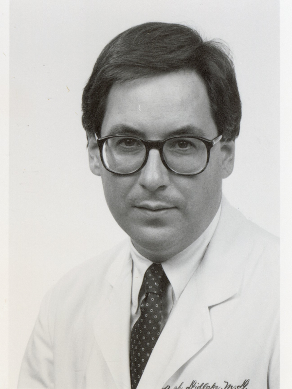 Dr. Ralph Didlake, shown here in his physician's white coat in the 1980's, graduated from the School of Medicine in 1979.