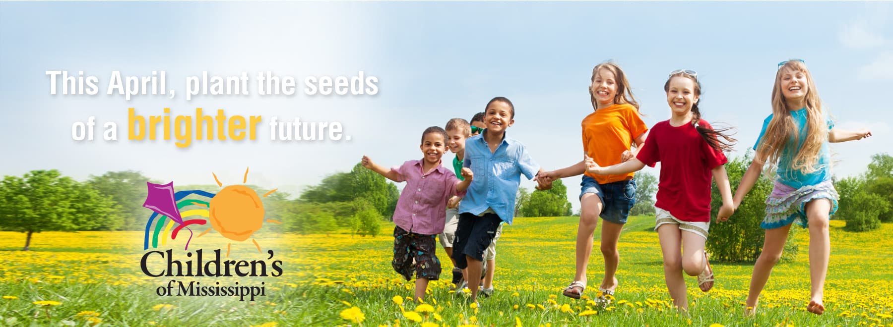 Diverse group of children running through field laughing with the message - This April, plant the seeds of a brighter future.